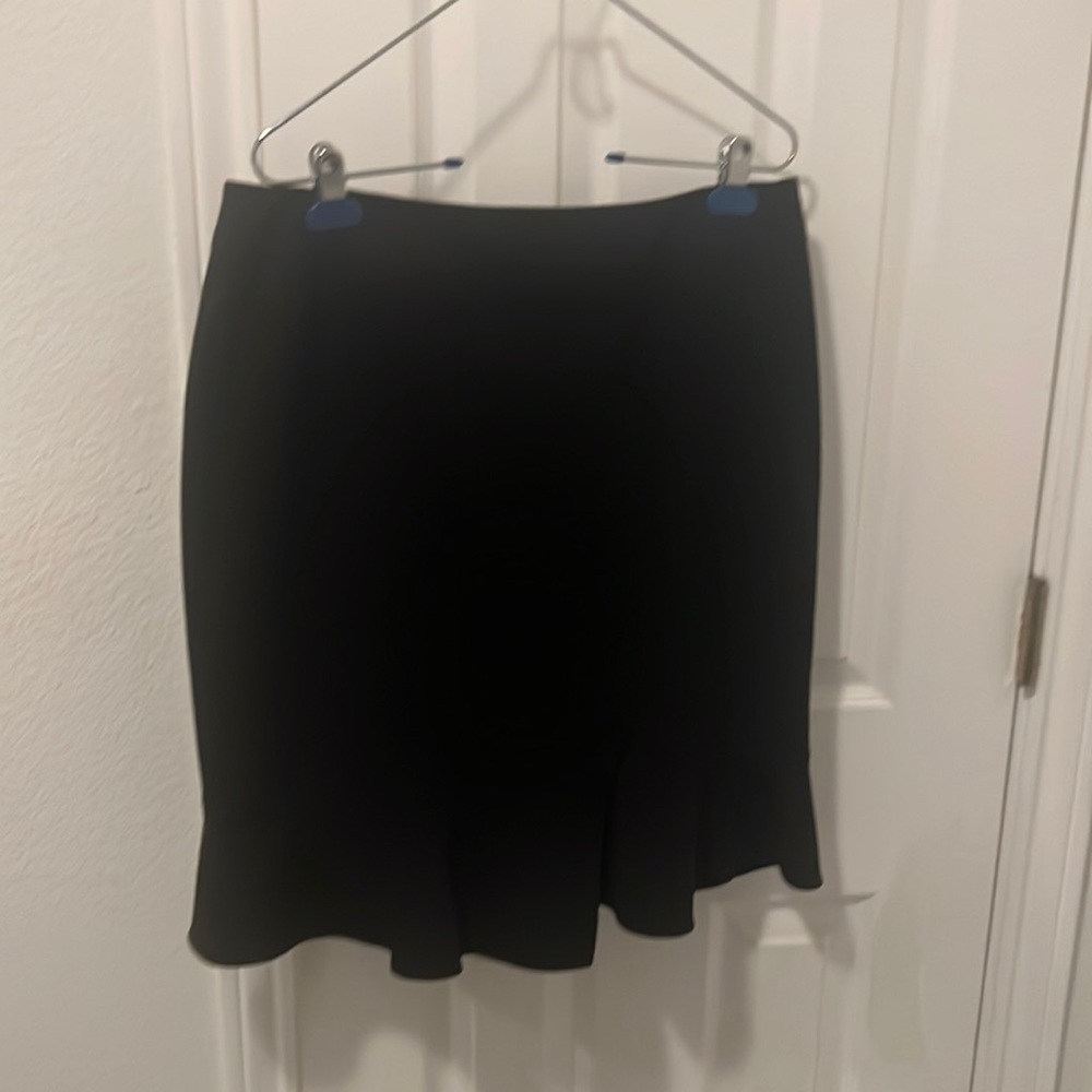 Knee length skirt with skirt flare and detail.